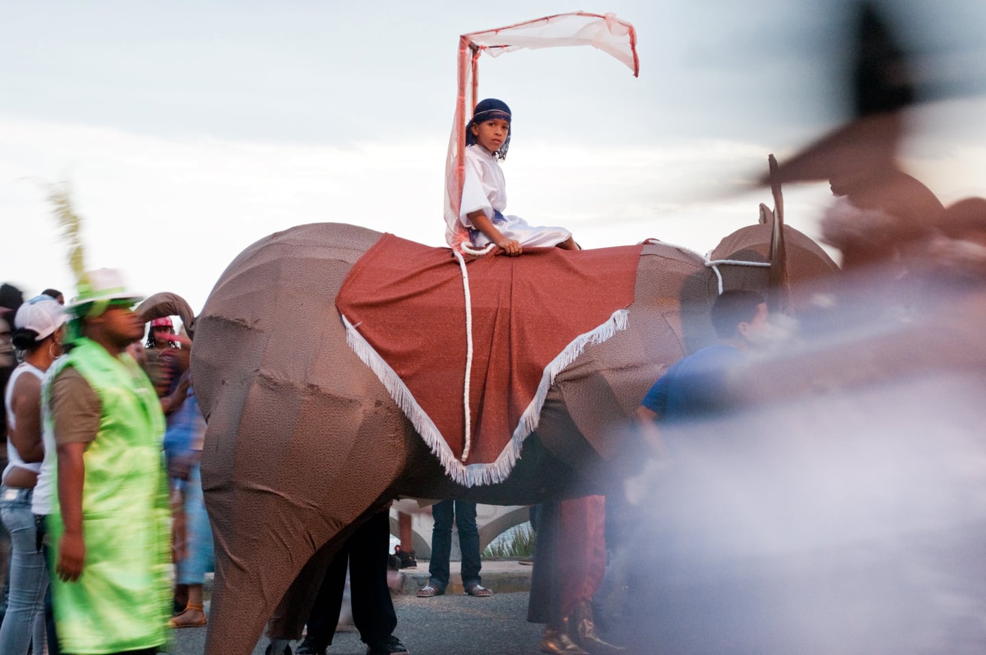 boy riding elephant in costume
