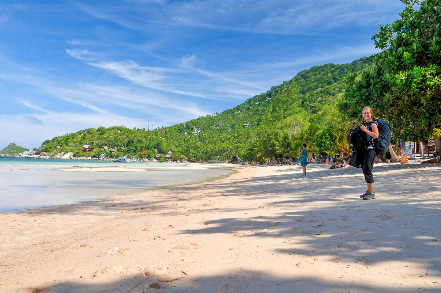 standing with backpack on Sairee Beach in Sairee Village Koh Tao Thailand