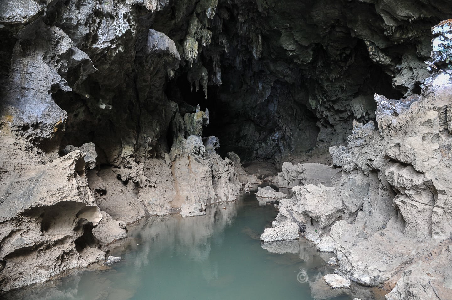 water-filled mouth of a mysterious cave