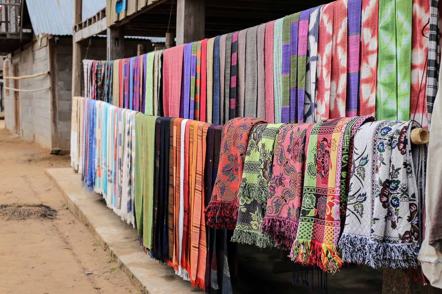 colorful Lao textiles on display in Sop Cham village